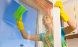 caretaker wiping window glass